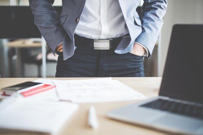 businessman-standing-in-his-office