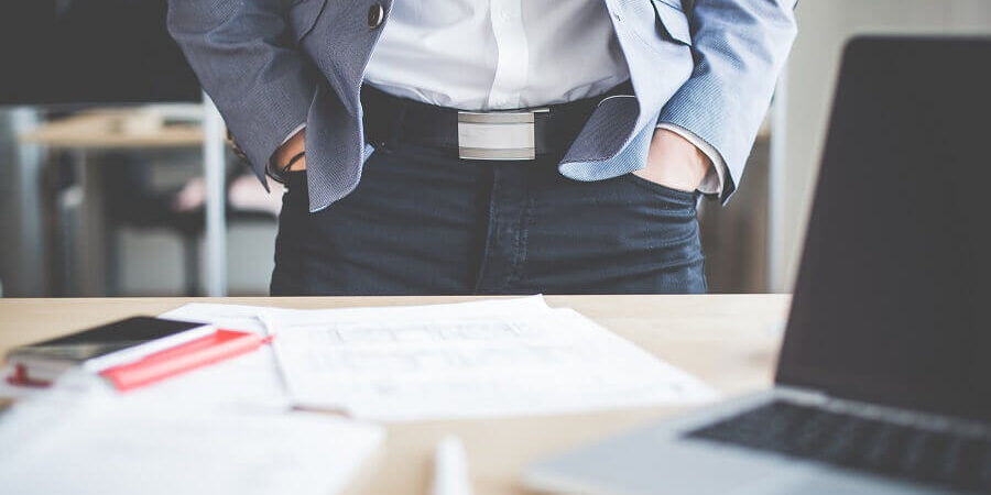 businessman-standing-in-his-office